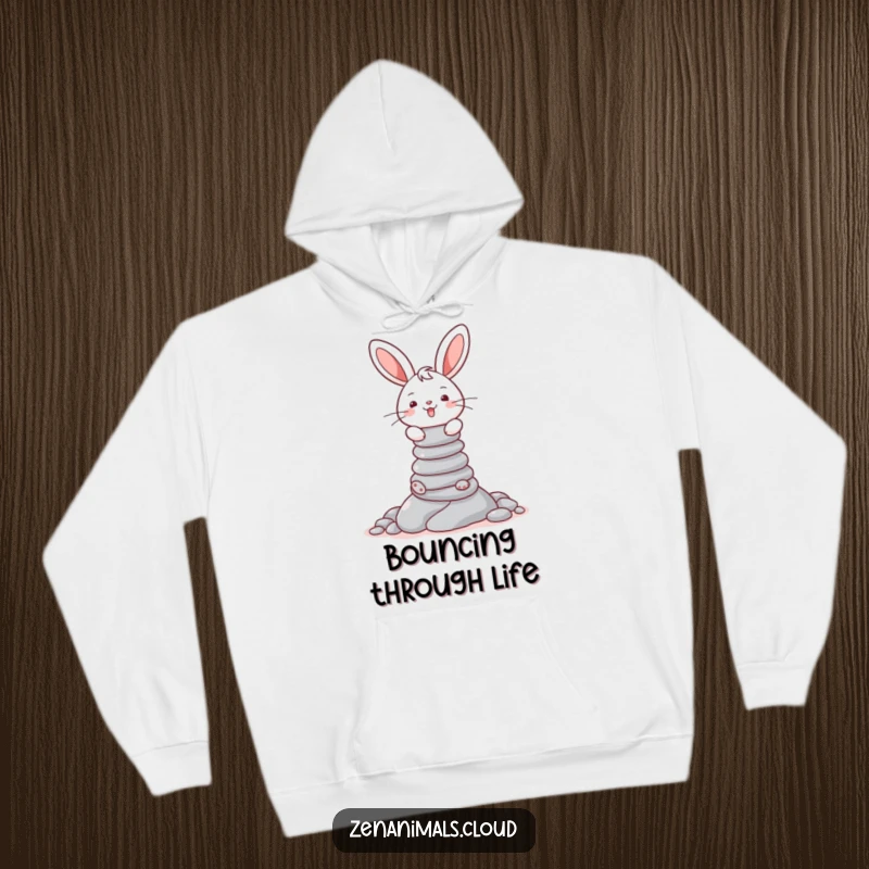 Funny hoodie with a cheerful bunny focused on balancing a tall stack of pebbles, radiating concentration.