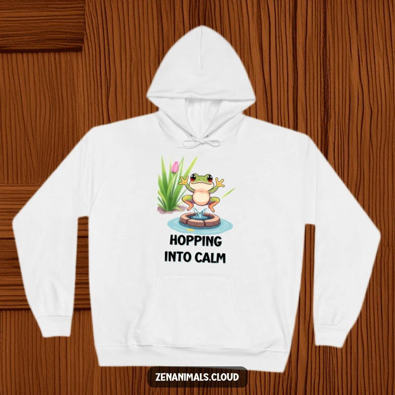 Funny frog meditation hoodie depicting a vibrant frog leaping with a splash into a small pond, a cozy and humorous apparel item.